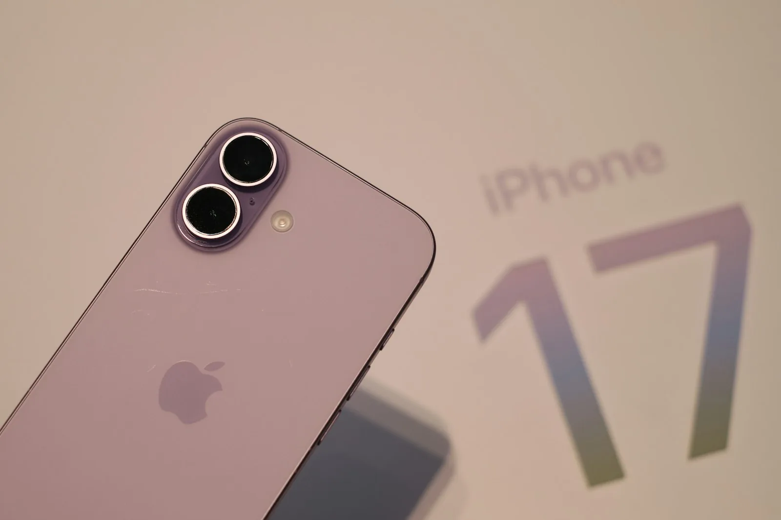 Close-up of a lavender iPhone 17 next to its box
